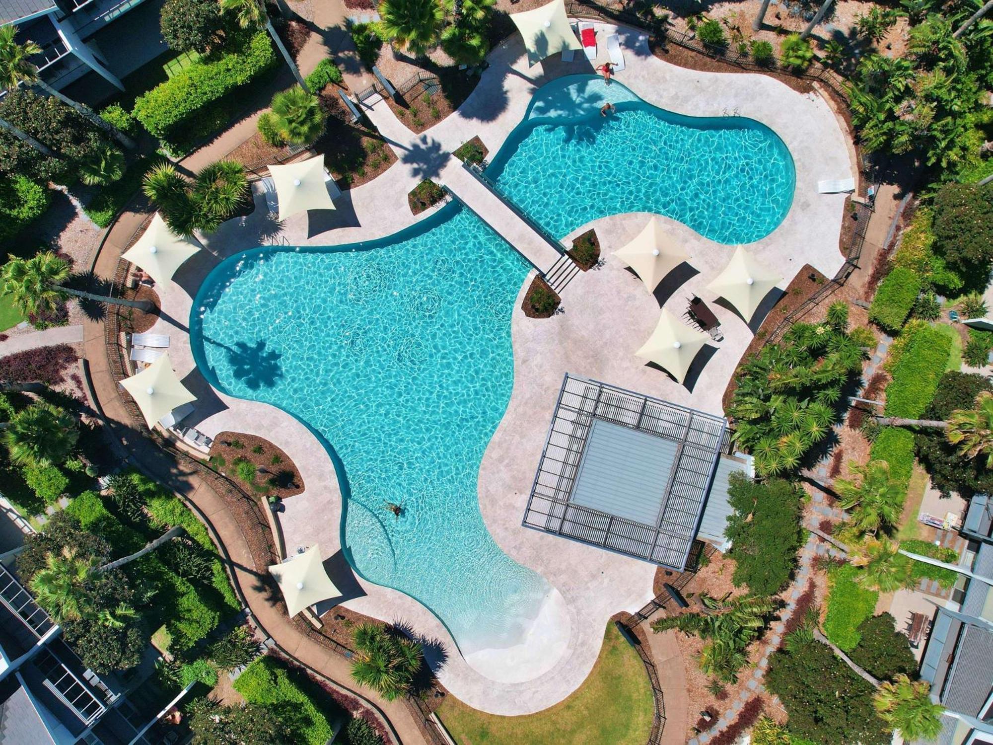 Pullman Magenta Shores Resort Entrance Exterior photo Aerial view of the pool